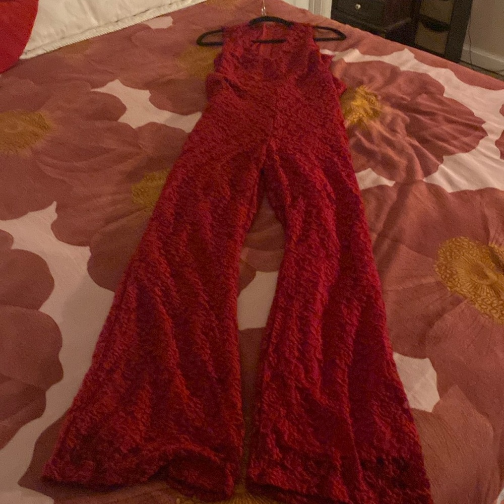 Beautiful Red Lace Jumpsuit with a half back and zipper.